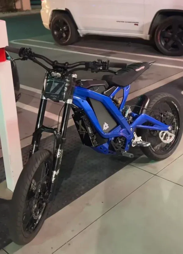 Blue electric dirt bike fitted with 17-inch supermoto wheels